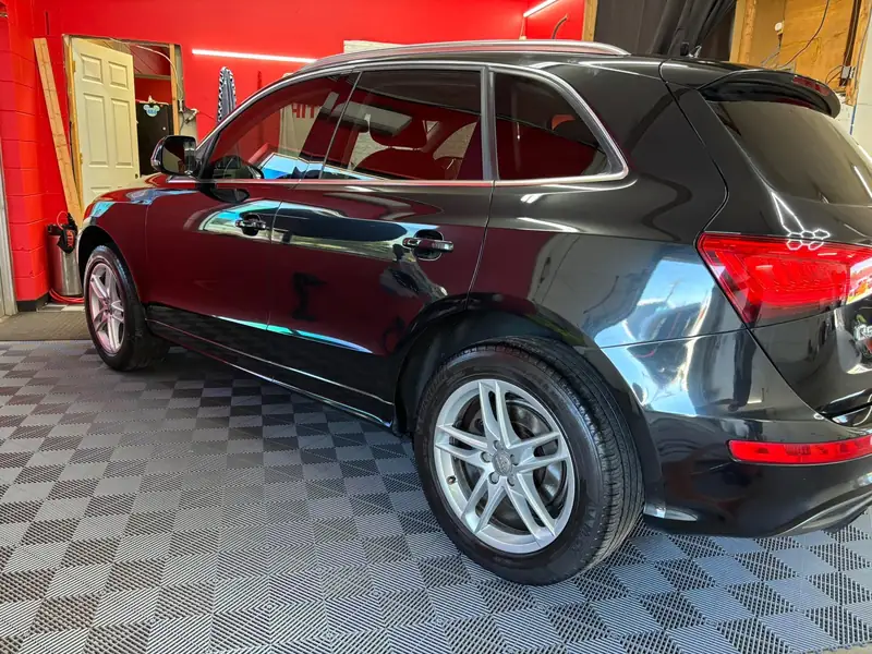 Black Audi Q5 with ceramic window tint in the red 502 Tinted bay, Louisville