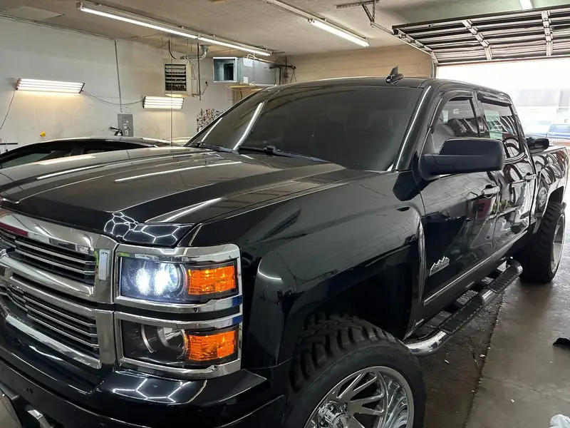 Black Chevy Silverado High Country with windshield film and tinted windows in the 502 Tinted bay