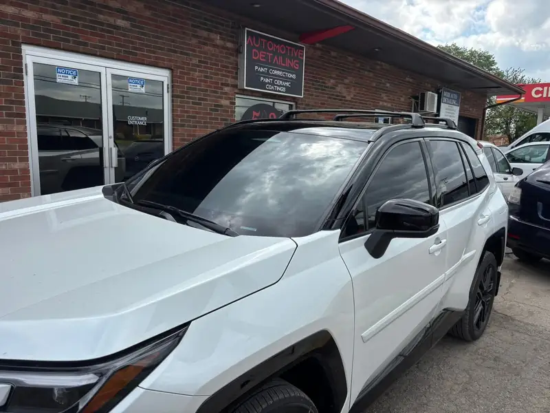 White Toyota RAV4 under the 502 Tinted automotive detailing sign