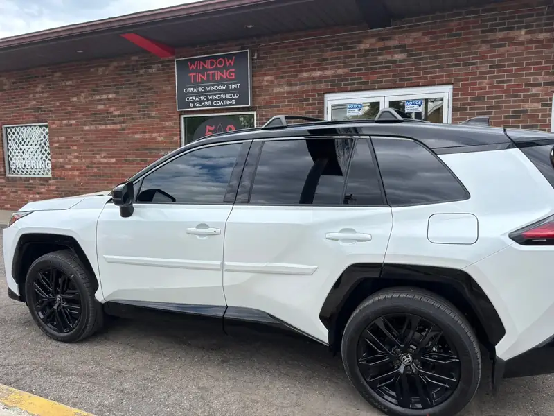 White Toyota RAV4 with dark ceramic tint, side view at 502 Tinted