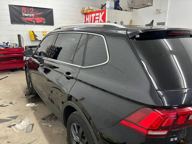 Black Volkswagen Tiguan with HITEK window tint, HITEK and 502 Tinted banners in the bay
